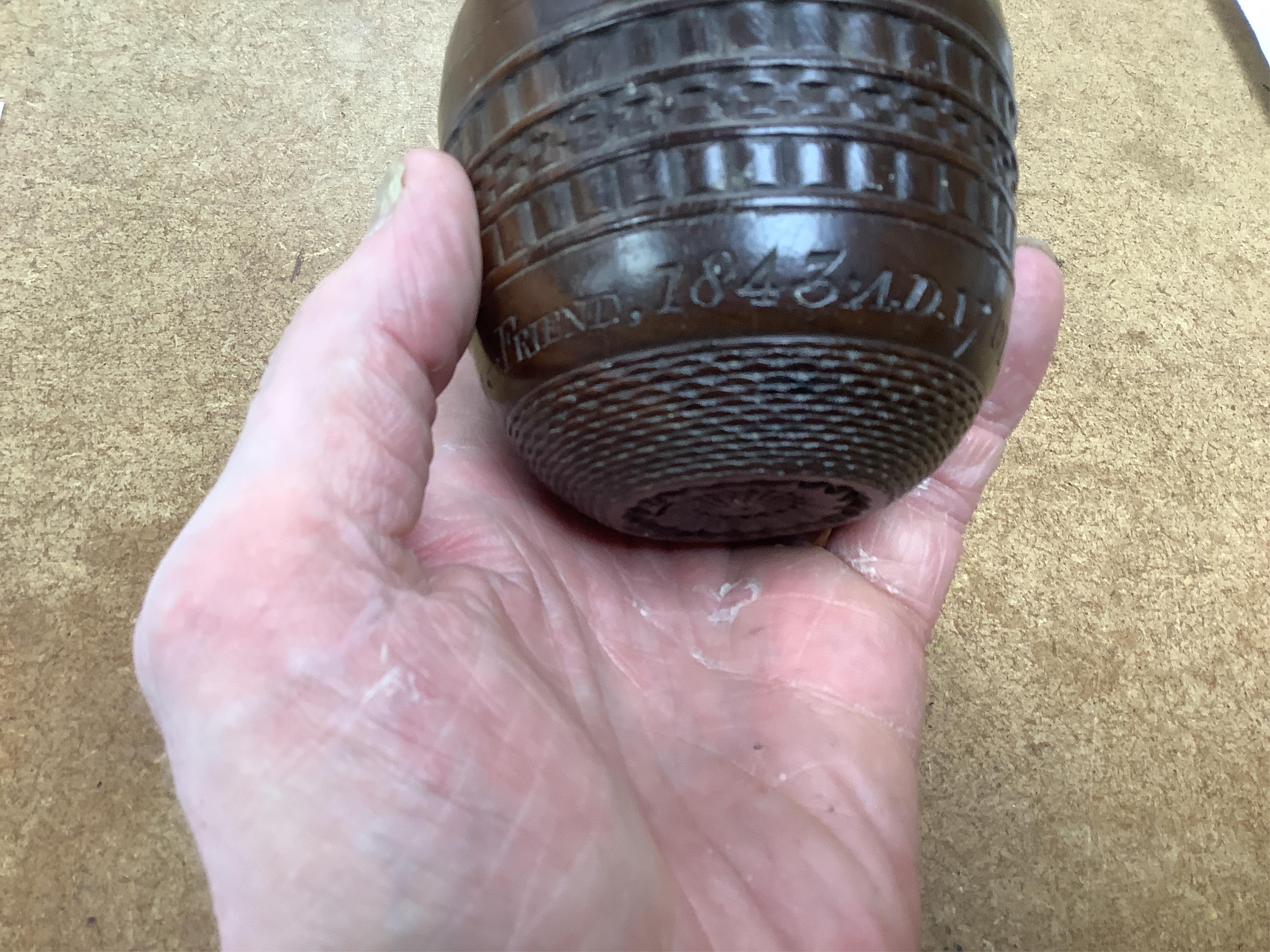A 19th century or earlier engine-turned lignum vitae tumbler cup, engraved ‘Presented to M. S. Jones by a Friend 1843 AD 1701 +’, 6.5cm high, by repute found on the roof plate of Kenwood house London in 2012, during reno